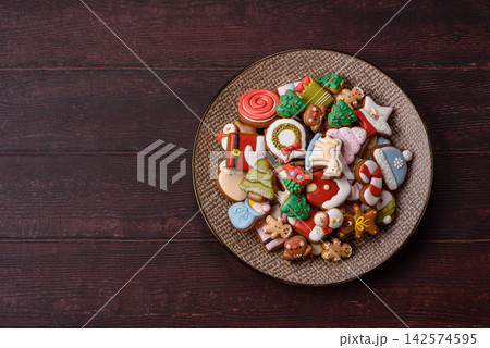 Gingerbread as a Christmas staple, sweets for the holiday interior. Gingerbread as a background Gingerbread as a Christmas staple, sweets for the holiday interior. Gingerbread as a background 142574595