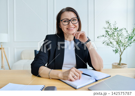 Webcam view woman entrepreneur, teacher, blogger working remotely in home office Webcam view woman entrepreneur, teacher, blogger working remotely in home office 142575787