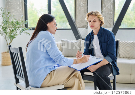 Teenager student talking to counselor in the office Teenager student talking to counselor in the office 142575863