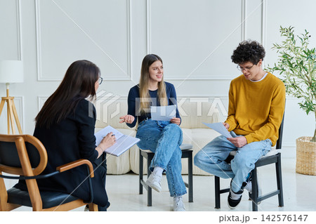 Group therapy, two students working with psychologist, counselor, mentor 142576147