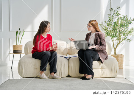 Sad teenage female patient in therapy session in psychologist office Sad teenage female patient in therapy session in psychologist office 142576196