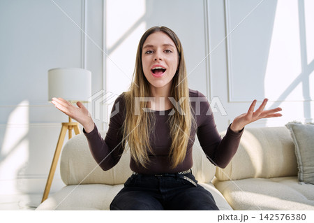 Web cam view of young woman talking looking in camera, online meeting, video call 142576380