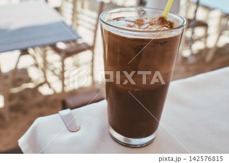 Close-up of a refreshing iced coffee frappe drink served in a tall glass Close-up of a refreshing iced coffee frappe drink served in a tall glass 142576815