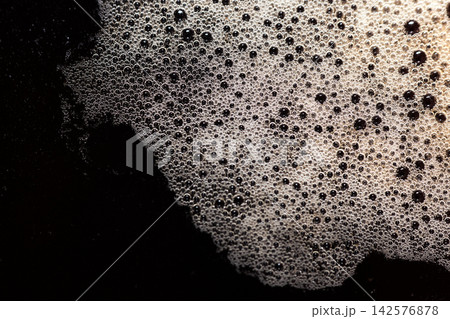Close-up shot of rich dark coffee crema with many small bubbles on top Close-up shot of rich dark coffee crema with many small bubbles on top 142576878