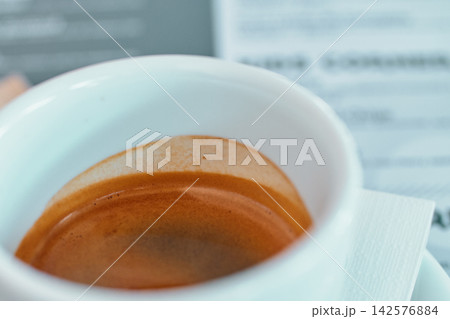 Close-up of a white ceramic cup filled with fresh aromatic espresso coffee Close-up of a white ceramic cup filled with fresh aromatic espresso coffee 142576884