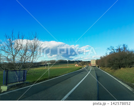 Slovakian road trip in winter. Two lane highway with driving white truck 142578052