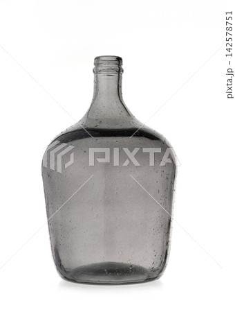 Empty vintage large grey glass bottle carboy isolated on white background with texture and small air bubbles inside Empty vintage large grey glass bottle carboy isolated on white background with texture and small air bubbles inside 142578751