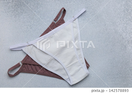Two pairs of underwear placed on a light gray background showing different colors and styles for casual wear Two pairs of underwear placed on a light gray background showing different colors and styles for casual wear 142578893