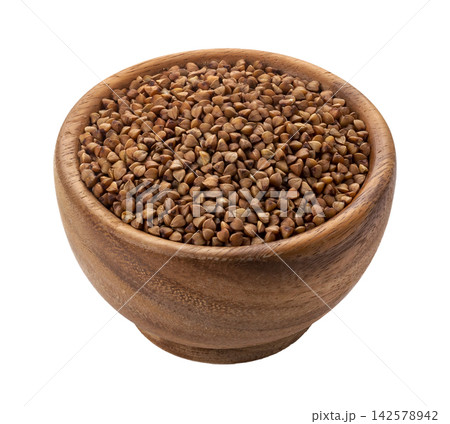Buckwheat groats in wooden bowl isolated on white background with clipping path Buckwheat groats in wooden bowl isolated on white background with clipping path 142578942