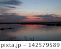 Venetian Lagoon sunset with pink clouds and water reflection Venetian Lagoon sunset with pink clouds and water reflection 142579589