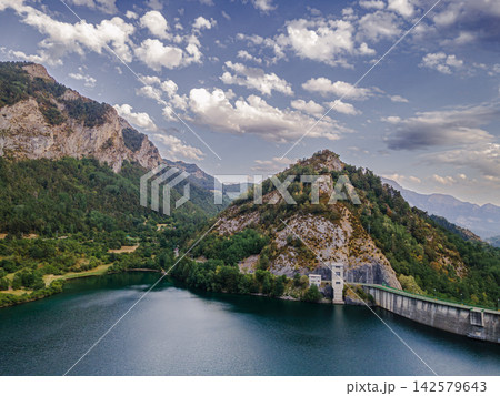 Lanuza Dam Wall and Mountain Reservoir. Aerial view of the Lanuza dam wall across the turquoise mountain reservoir in the Tena Valley of Aragon, Spain, a scenic image of hydro engineering set within t 142579643