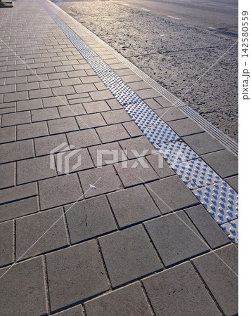 Road Markings on a City Sidewalk Create a Vibrant Urban Scene 142580559