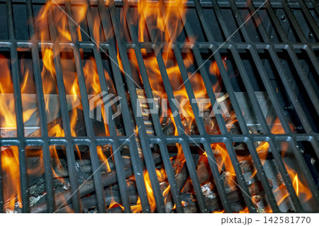 Intense Open Flame Beneath Barbecue Grill Grate Outdoors 142581770