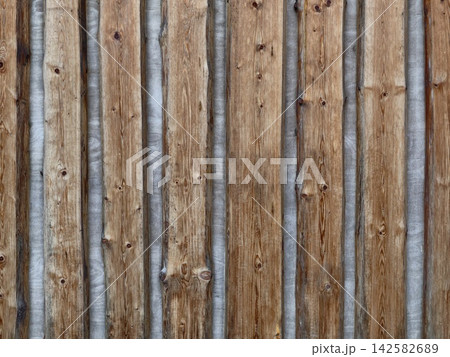 straight wooden fence with metal strips in an outdoor setting, neutral and clean background for copy space and design resources, modern and warm tones, architectural and design. straight wooden fence with metal strips in an outdoor setting, neutral and clean background for copy space and design resources, modern and warm tones, architectural and design. 142582689