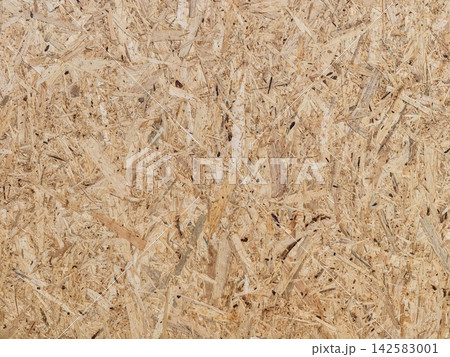 Oriented strand board surface texture with rough wood chips, beige brown tones, irregular construction pattern, natural grain, subtle shadows, rustic industrial material background Oriented strand board surface texture with rough wood chips, beige brown tones, irregular construction pattern, natural grain, subtle shadows, rustic industrial material background 142583001