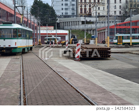 Construction zone with safety measures. Steel plates and building supplies situated near railway tracks Construction zone with safety measures. Steel plates and building supplies situated near railway tracks 142584323