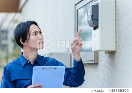 電力メーターを確認する男性作業員 142586306