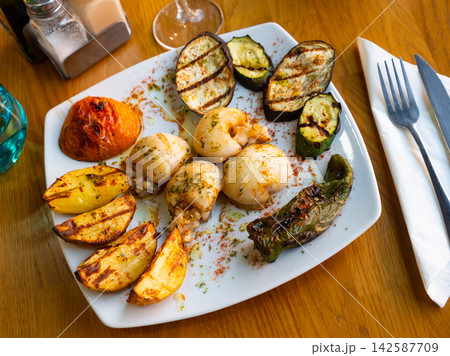 Cuttlefish served with potatoes and vegetables Cuttlefish served with potatoes and vegetables 142587709