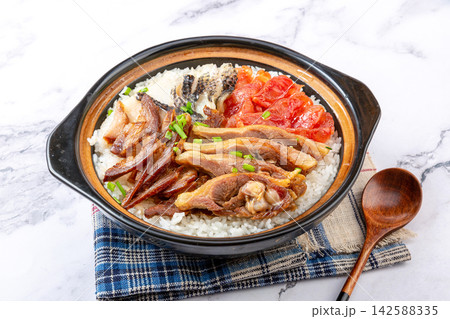 Chinese deluxe four-in-one combo claypot rice with assorted meats and sausages on marble background 142588335