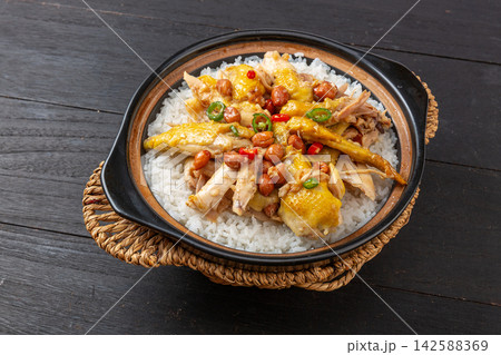 Chinese claypot rice with tender steamed chicken, peanuts and chili pepper, top view Chinese claypot rice with tender steamed chicken, peanuts and chili pepper, top view 142588369