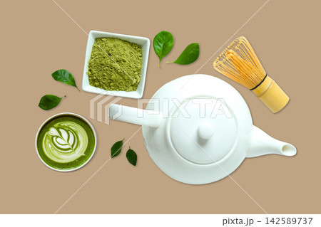 Matcha. Matcha powder, whisk, and tea leaves arranged for preparation Matcha. Matcha powder, whisk, and tea leaves arranged for preparation 142589737