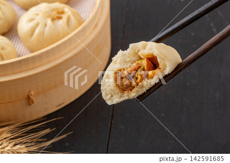 steamed pork and shiitake mushroom xiaolongbao soup dumplings in bamboo steamer, Chinese dim sum steamed pork and shiitake mushroom xiaolongbao soup dumplings in bamboo steamer, Chinese dim sum 142591685