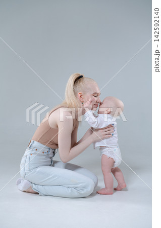 Young Mother and Baby Boy Touching Noses, Tender Moment 142592140