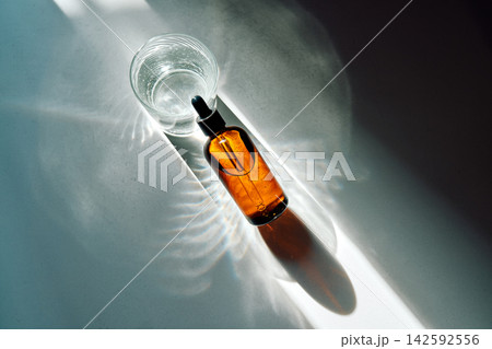 Skincare product bottle and glass with water Skincare product bottle and glass with water 142592556