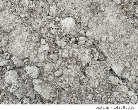 Plowed field dark soil ground texture Plowed field dark soil ground texture 142593319