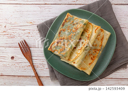 pan-fried Chinese chive and egg pockets, Sanxian vegetable turnover pancake served with chili dipping sauce. pan-fried Chinese chive and egg pockets, Sanxian vegetable turnover pancake served with chili dipping sauce. 142593409