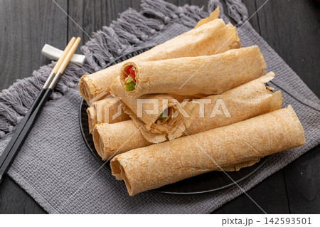 traditional Shandong multigrain crepes wrapped into rolls, authentic Chinese grain tortilla pancakes with dipping sauce. traditional Shandong multigrain crepes wrapped into rolls, authentic Chinese grain tortilla pancakes with dipping sauce. 142593501