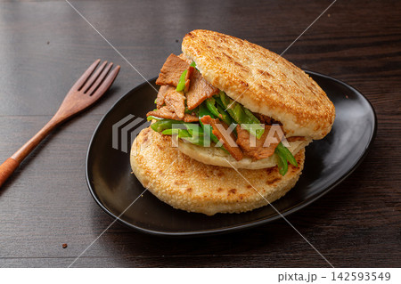 chinese rougamo pork burger stuffed with stir fried pork slices and green pepper 142593549