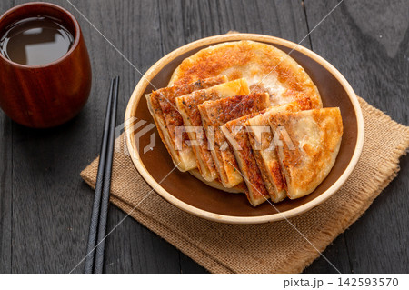 pan fried Chinese meat pies stuffed with black pepper beef filling on ceramic plate pan fried Chinese meat pies stuffed with black pepper beef filling on ceramic plate 142593570