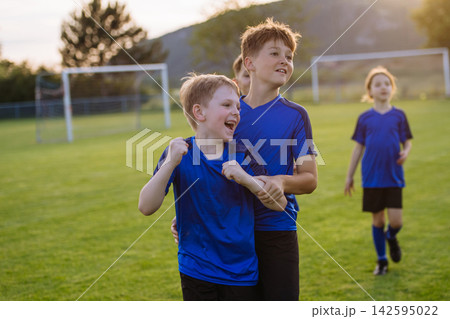 Young football team celebrating goal. Young football team celebrating goal. 142595022