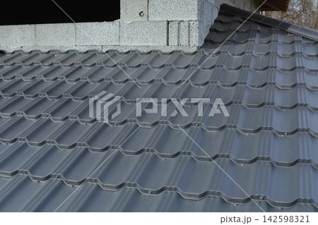 Corrugated metal roof and metal roofing. Modern roof made of metal. 142598321