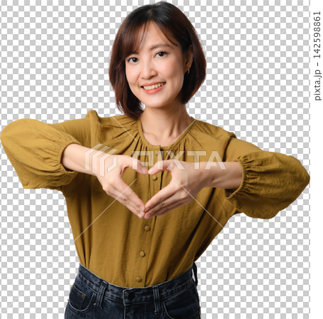 Asian woman forming heart with hands and smiling in mustard blouse on transparent background for affection and kindness Asian woman forming heart with hands and smiling in mustard blouse on transparent background for affection and kindness 142598861