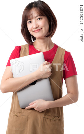 Asian woman holding laptop with warm smile in casual workwear isolated on transparent background for business and technology use 142598871