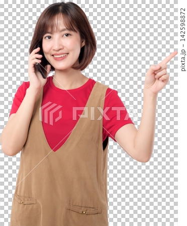 Asian woman holding smartphone and pointing upward with cheerful expression isolated on transparent background 142598872