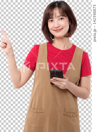 Asian woman holding smartphone and pointing upward with friendly smile isolated on transparent background 142598873