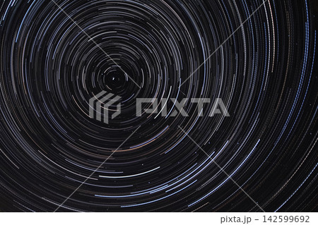 Long exposure starry sky, twisted tracks of stars. 142599692