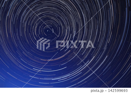 Long exposure starry sky, twisted tracks of stars. 142599693