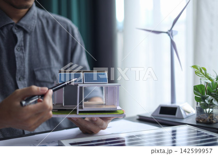 Architect Working on renewable Energy Housing Project. 142599957
