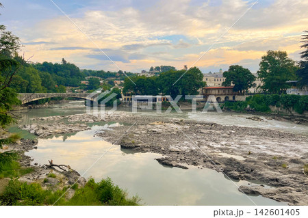 Beautiful sunrise in Kutaisi. Rioni river bridge architecture and dawn sky with clouds Georgia 142601405