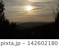 Sunset over mountain range with silhouette of evergreen trees 142602180