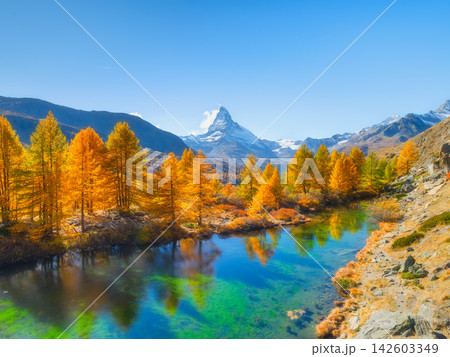 Matterhorn mountain in Switzerland reflects in a calm alpine lake. Matterhorn mountain in Switzerland reflects in a calm alpine lake. 142603349