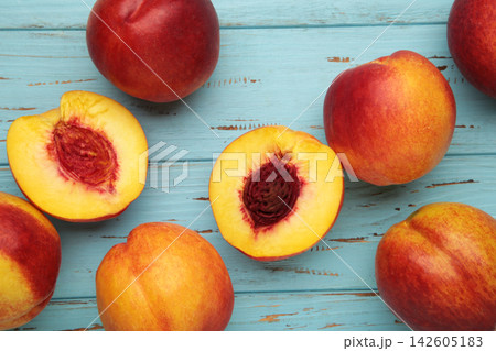 Fresh ripe nectarine on blue wooden background. Fresh ripe nectarine on blue wooden background. 142605183