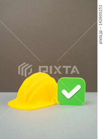Construction helmet and approval checkmark, building permit approval, license approval concept. Construction authorization, regulatory compliance, certification and official permission Construction helmet and approval checkmark, building permit approval, license approval concept. Construction authorization, regulatory compliance, certification and official permission 142605251