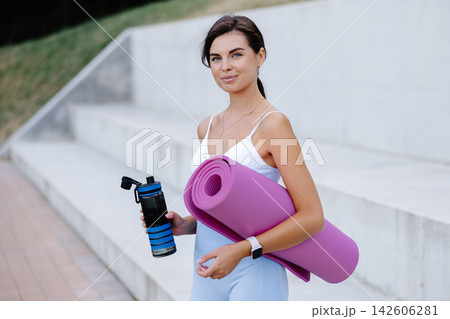 Young woman drinking water after outdoor workout Young woman drinking water after outdoor workout 142606281