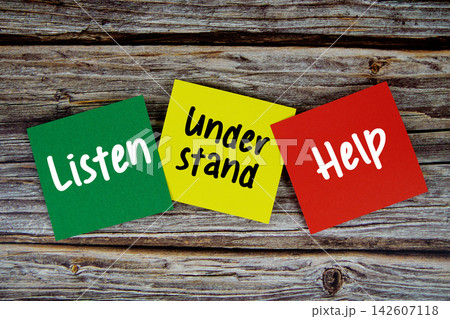 Listen, Understand, Help message on paper note flat lay on wooden background Listen, Understand, Help message on paper note flat lay on wooden background 142607118