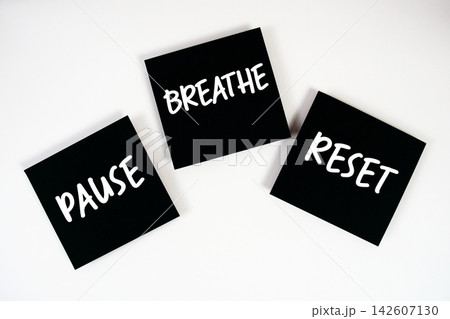 Pause, Breathe, Reset message on paper note flat lay on pink background Pause, Breathe, Reset message on paper note flat lay on pink background 142607130